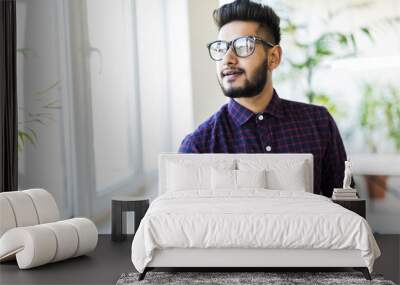 Happy Indian business man in glasses at the office. Wall mural